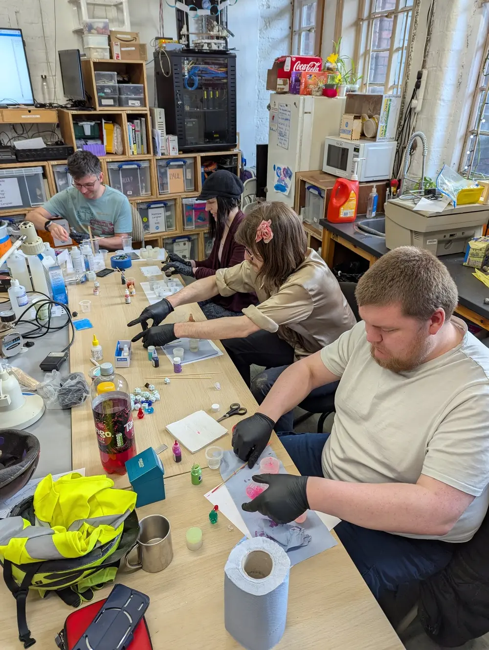 picture of several people mixing or pouring resin