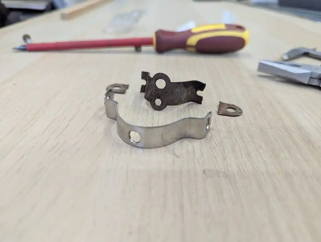 picture of broken bike mudguard bracket and fixed bracket