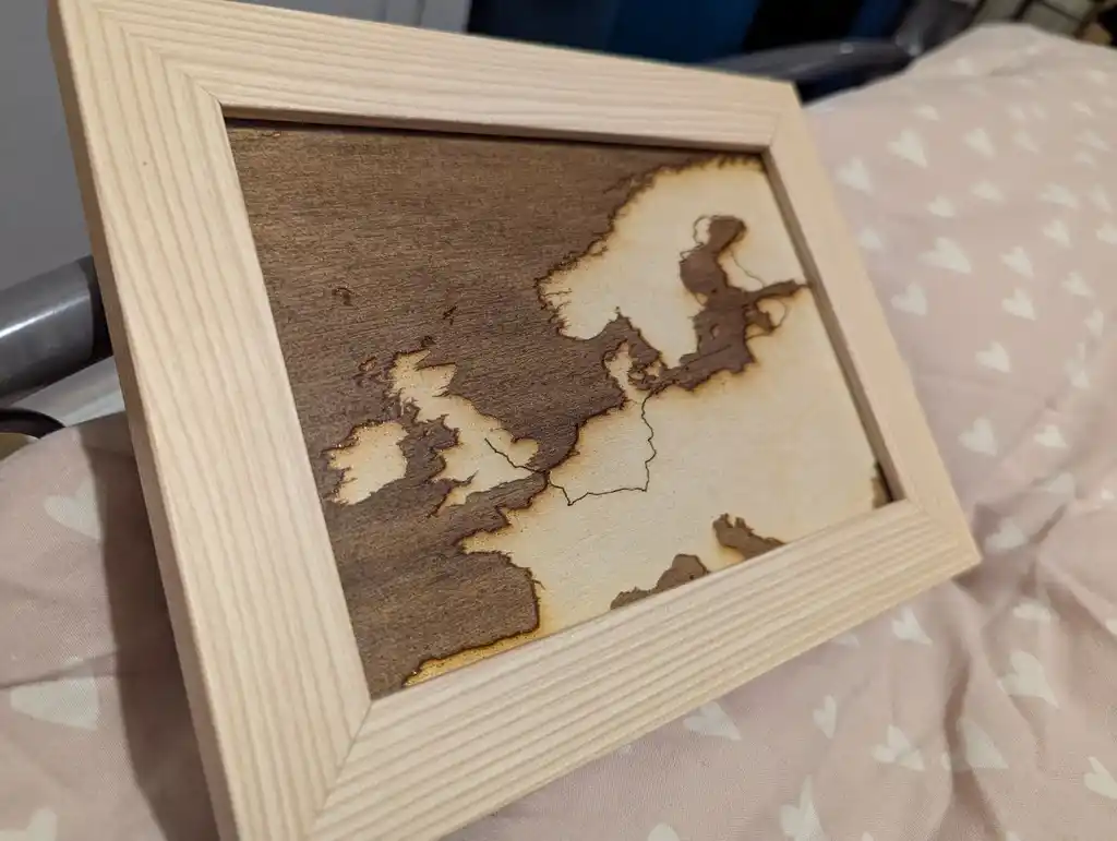 picture of a laser-engraved wooden map in a frame
