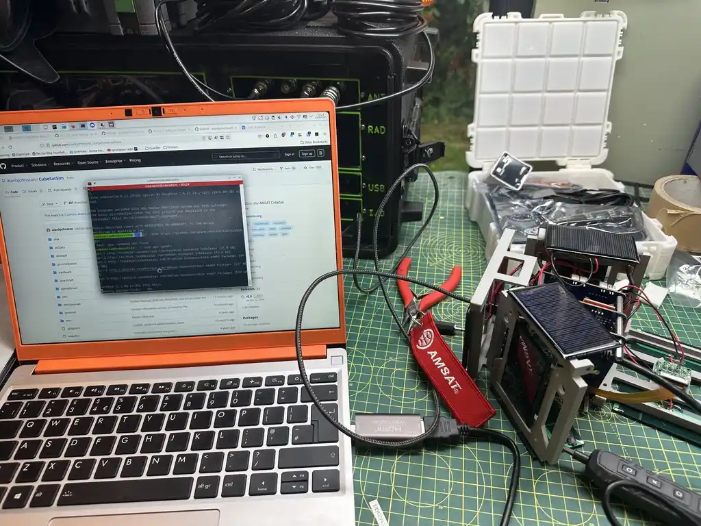 picture of cubesat simulator next to computer connected to it