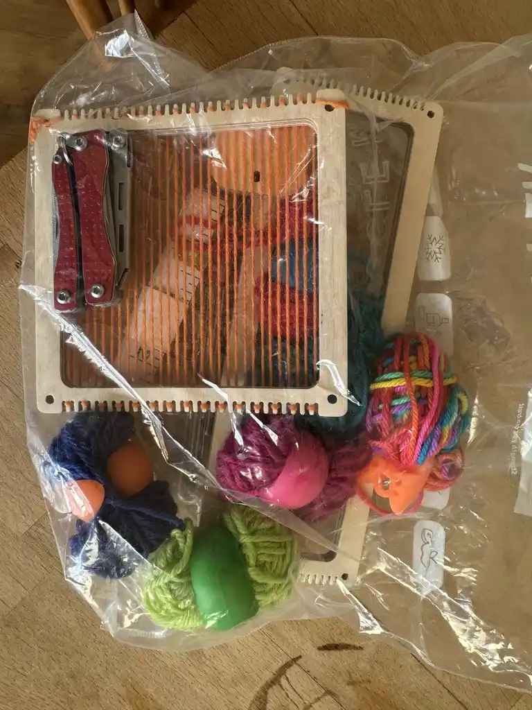 picture of a bag of wool and a weaving frame