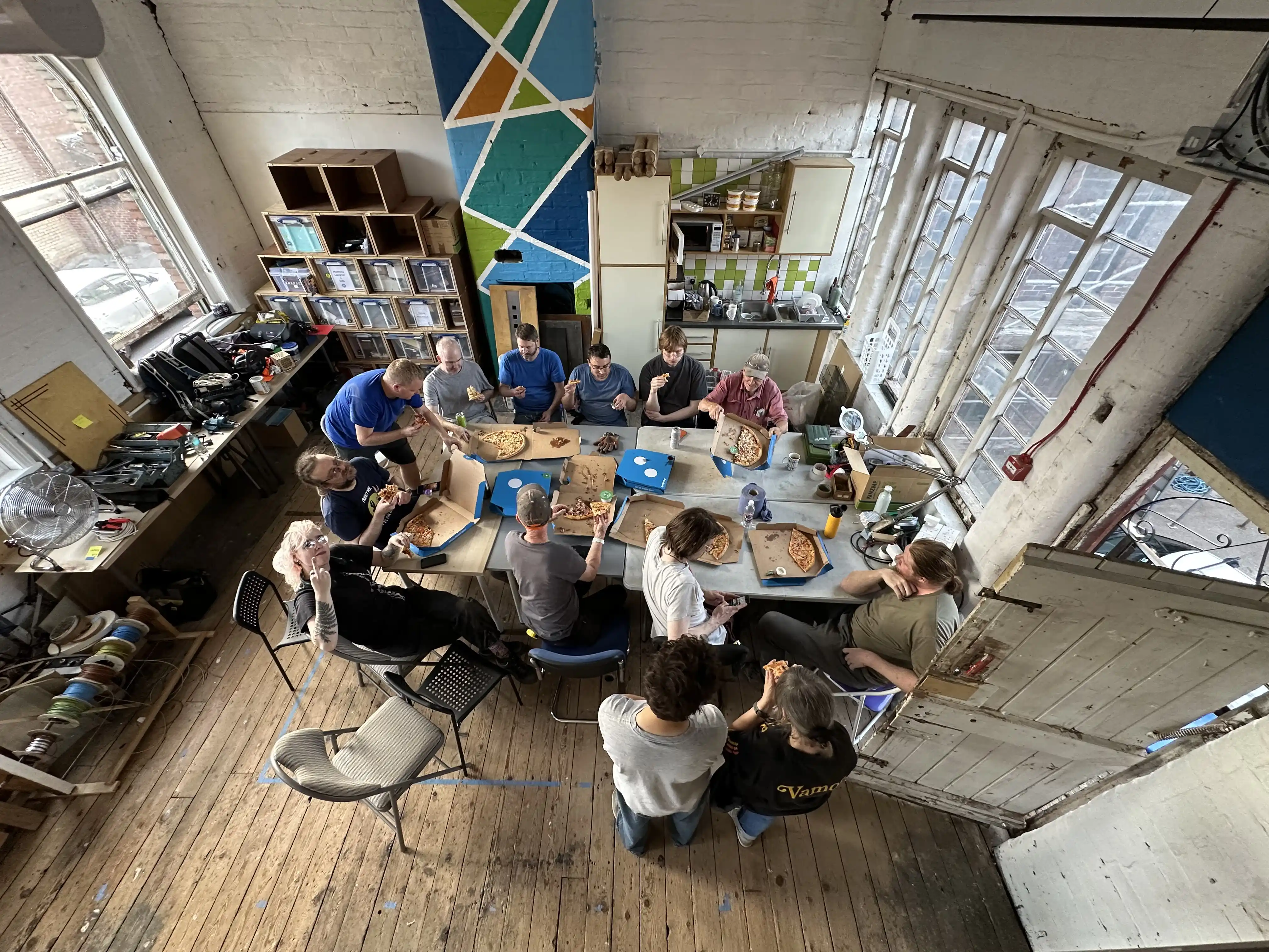 high-angle picture of group eating pizza
