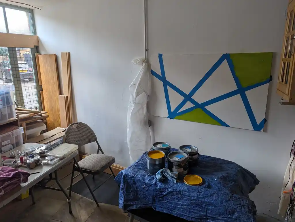 picture of a room with half-painted board on the wall