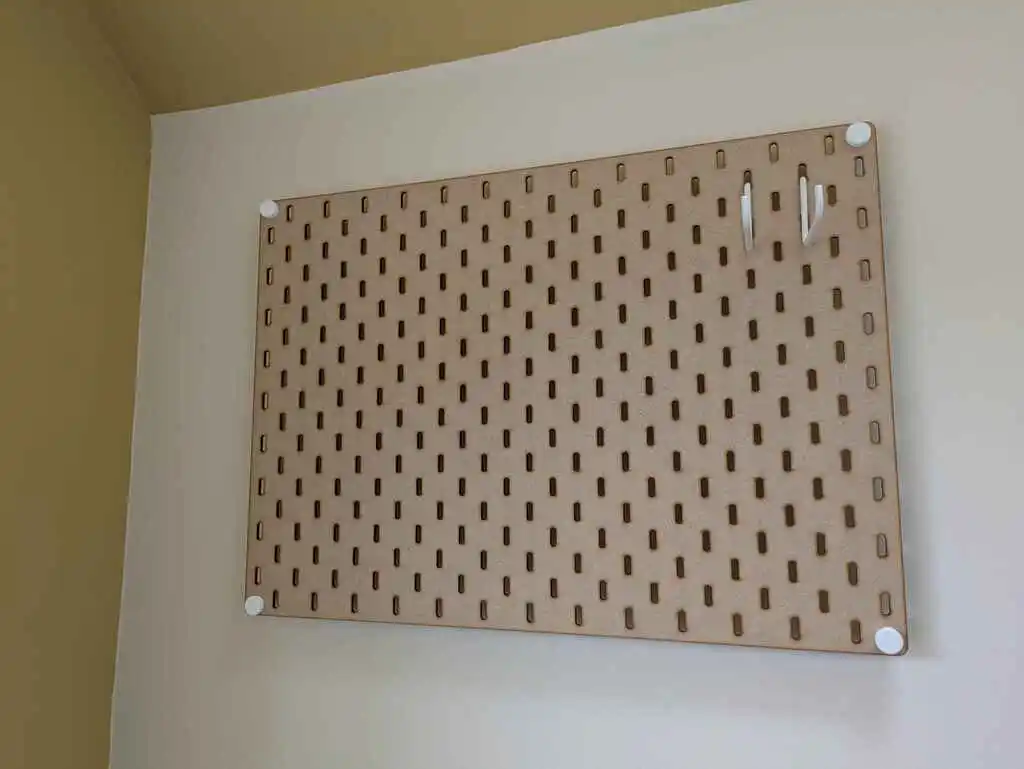picture of a large laser-cut "Skadis" board with regular rectangular holes