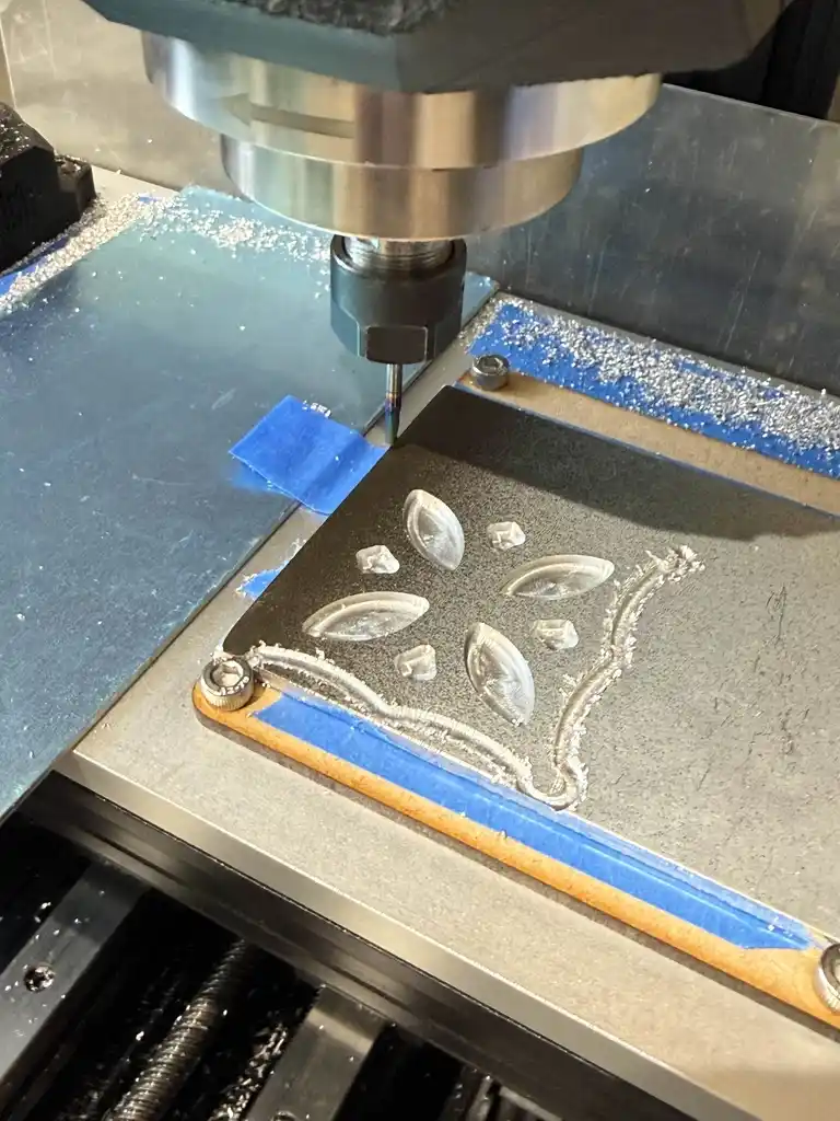 picture of metal geometric shape being cut by CNC machine