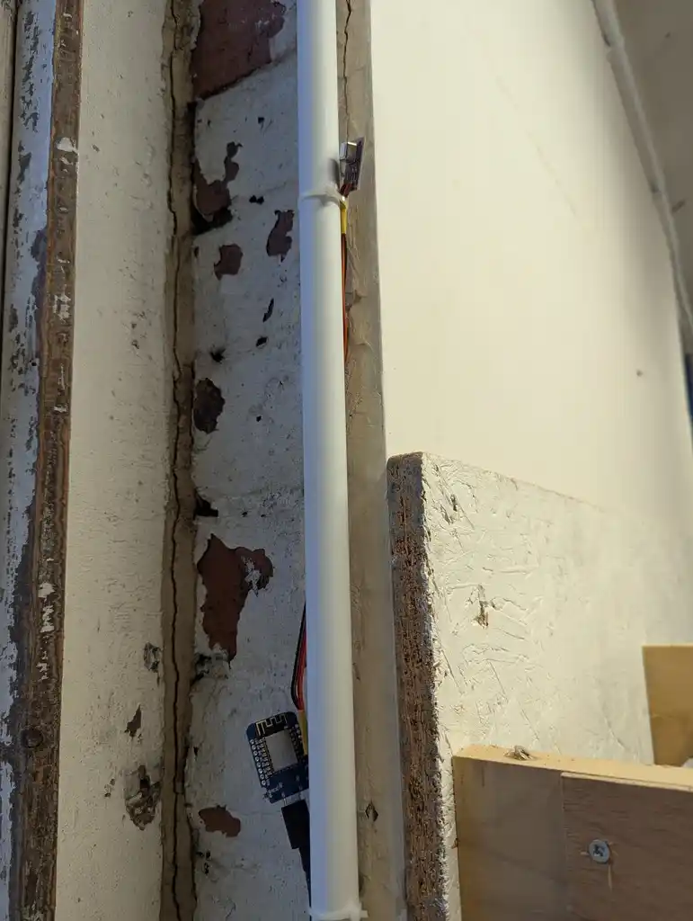 picture of environment monitor hidden behind some cable conduit