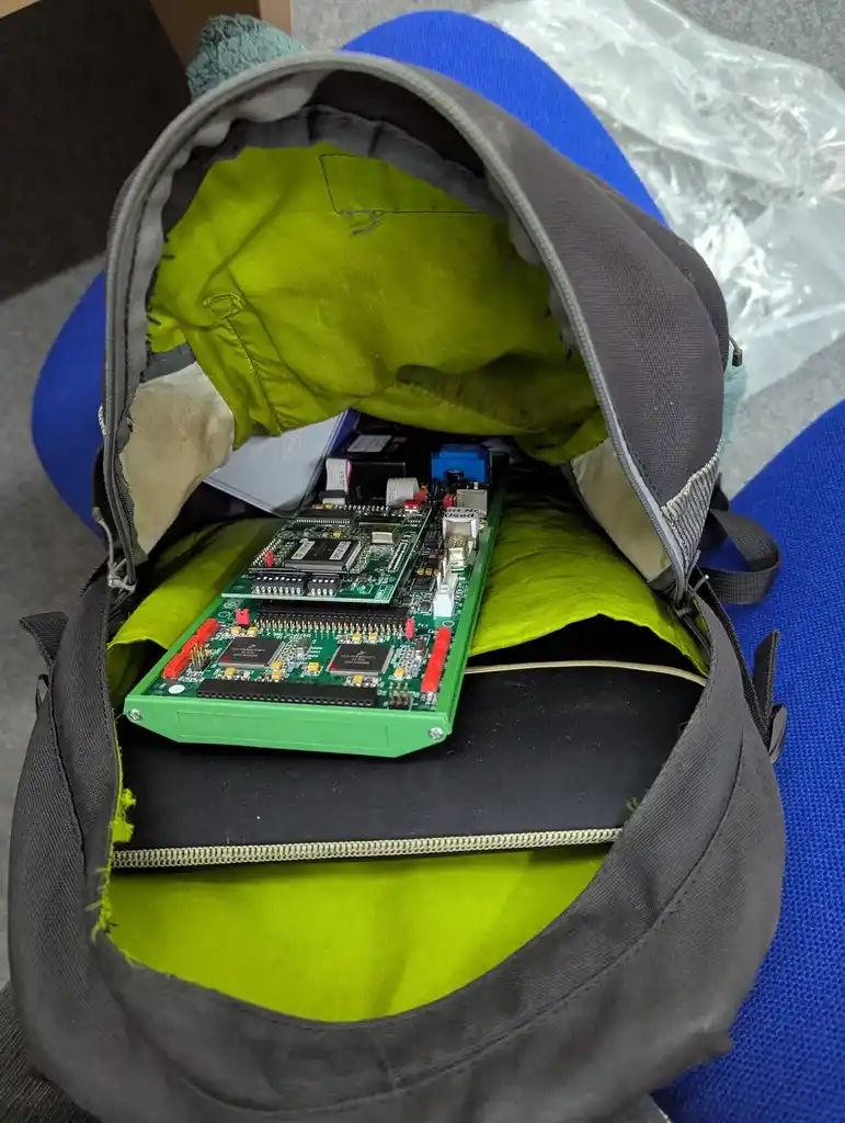 picture of large electronics board being carried around in backpack