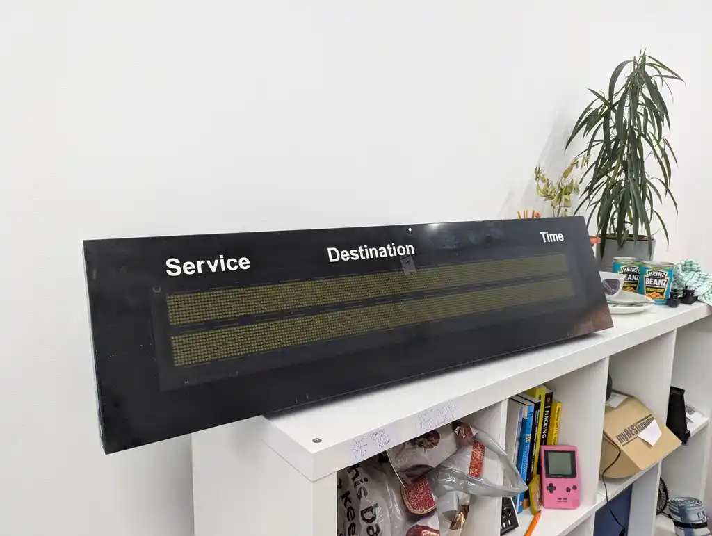 picture of bus sign with weather hatch closed, showing "Service", "Destination", and "Time" labels above LED matrix display