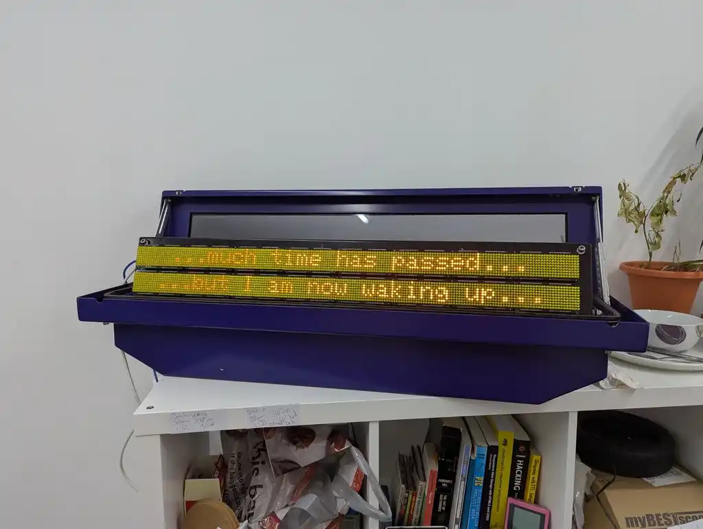 picture of LED matrix bus sign displaying the text "much time has passed" "but I am now waking up"