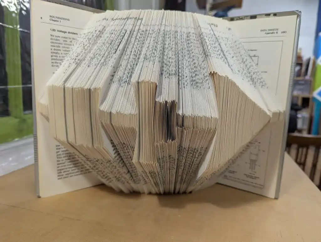 picture of The Art of Electronics book, with each page folded so the side-on view looks like a circuit