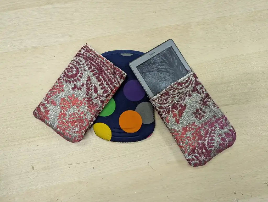 picture of three Amazon Kindle 4s, each in a case