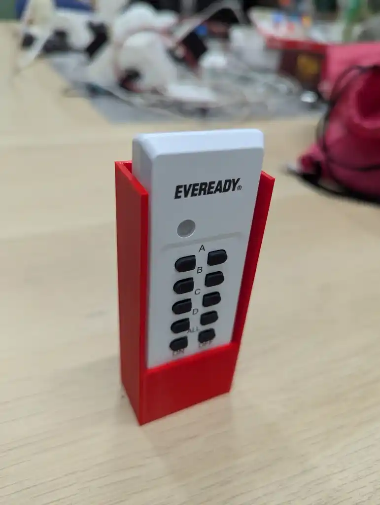 picture of a 3D printed remote holder, with the remote inside it