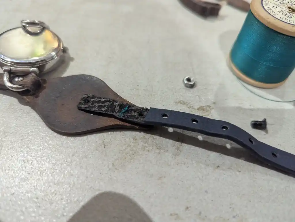 picture of a watch, with strap mostly attached, sewed