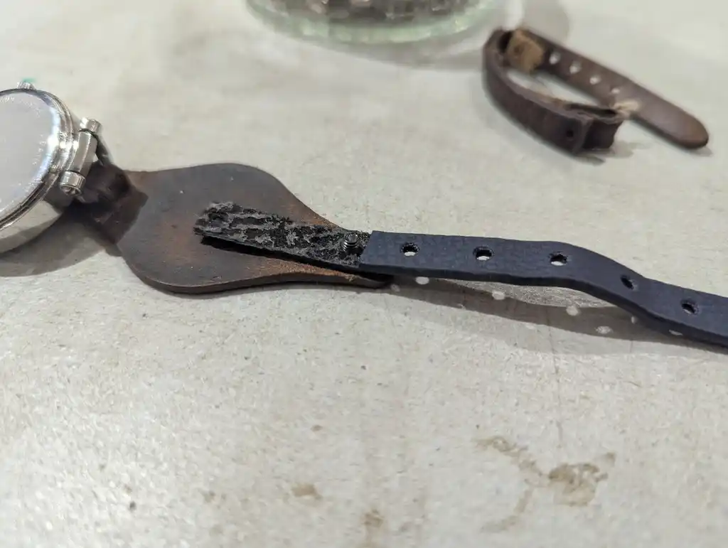 picture of a watch, with strap partly attached