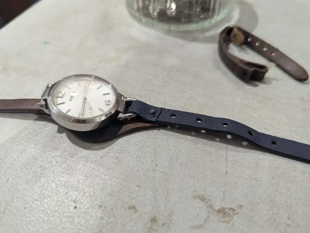 picture of a watch, with strap mostly attached