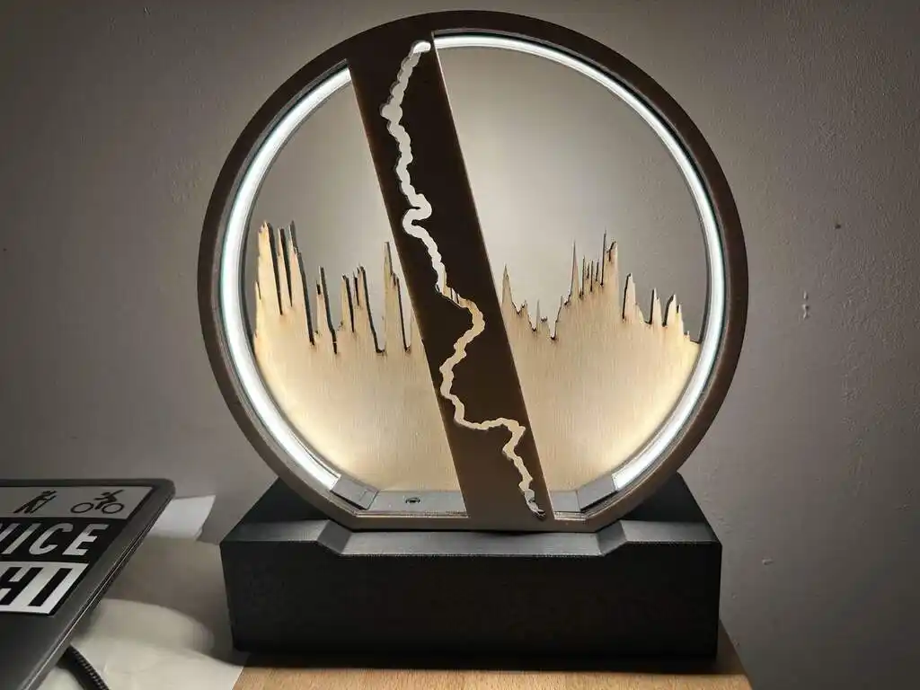 picture of circular lamp, showing an abstract running route and elevation profile