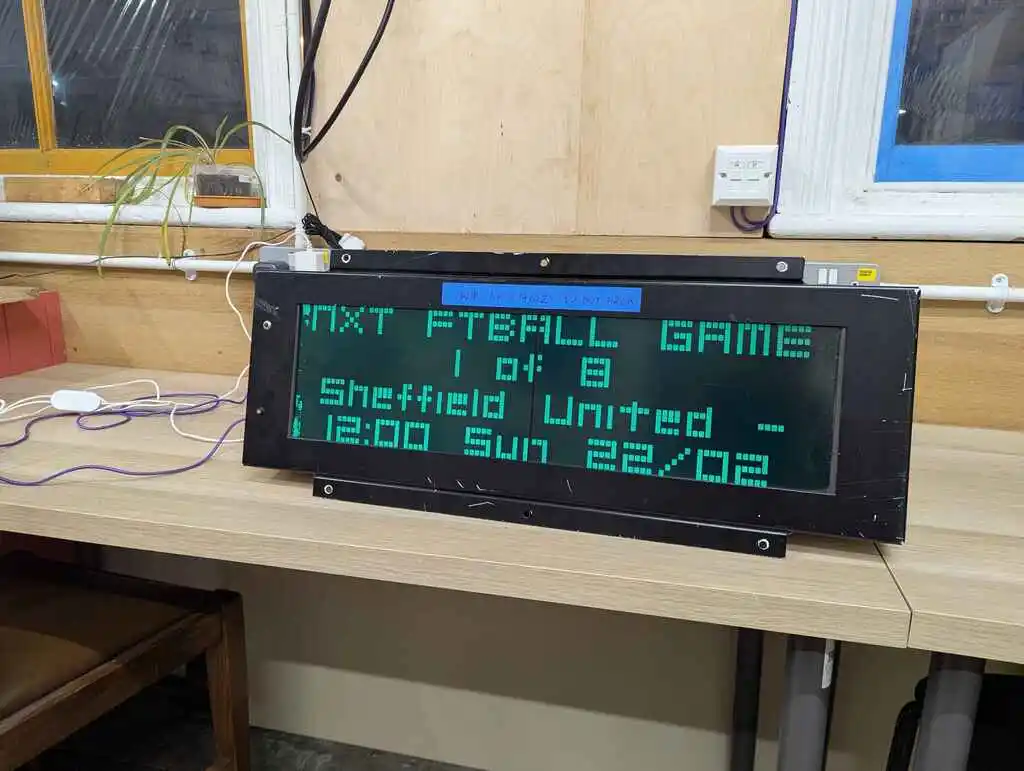 picture of large LCD train sign displaying football fixtures