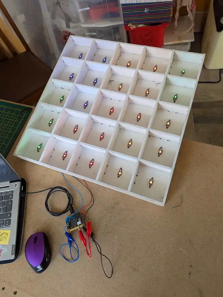 picture of drawer full of grid of LEDs, which are lit up colours