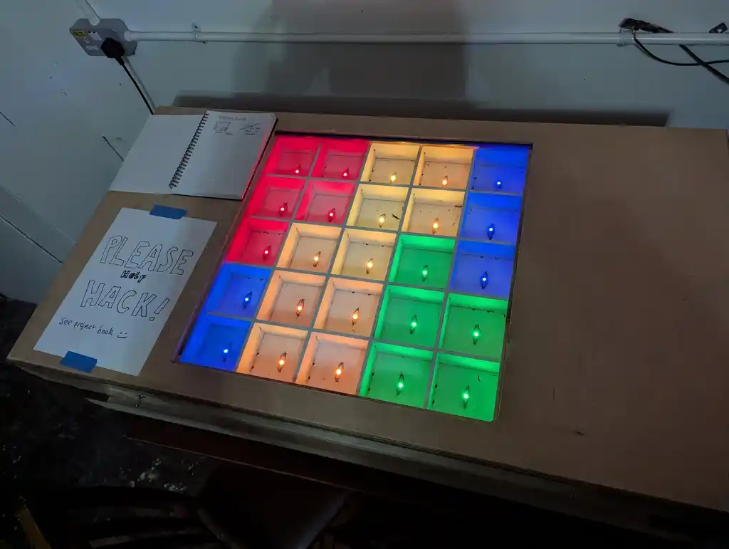picture of drawer full of grid of LEDs, which are lit up colours