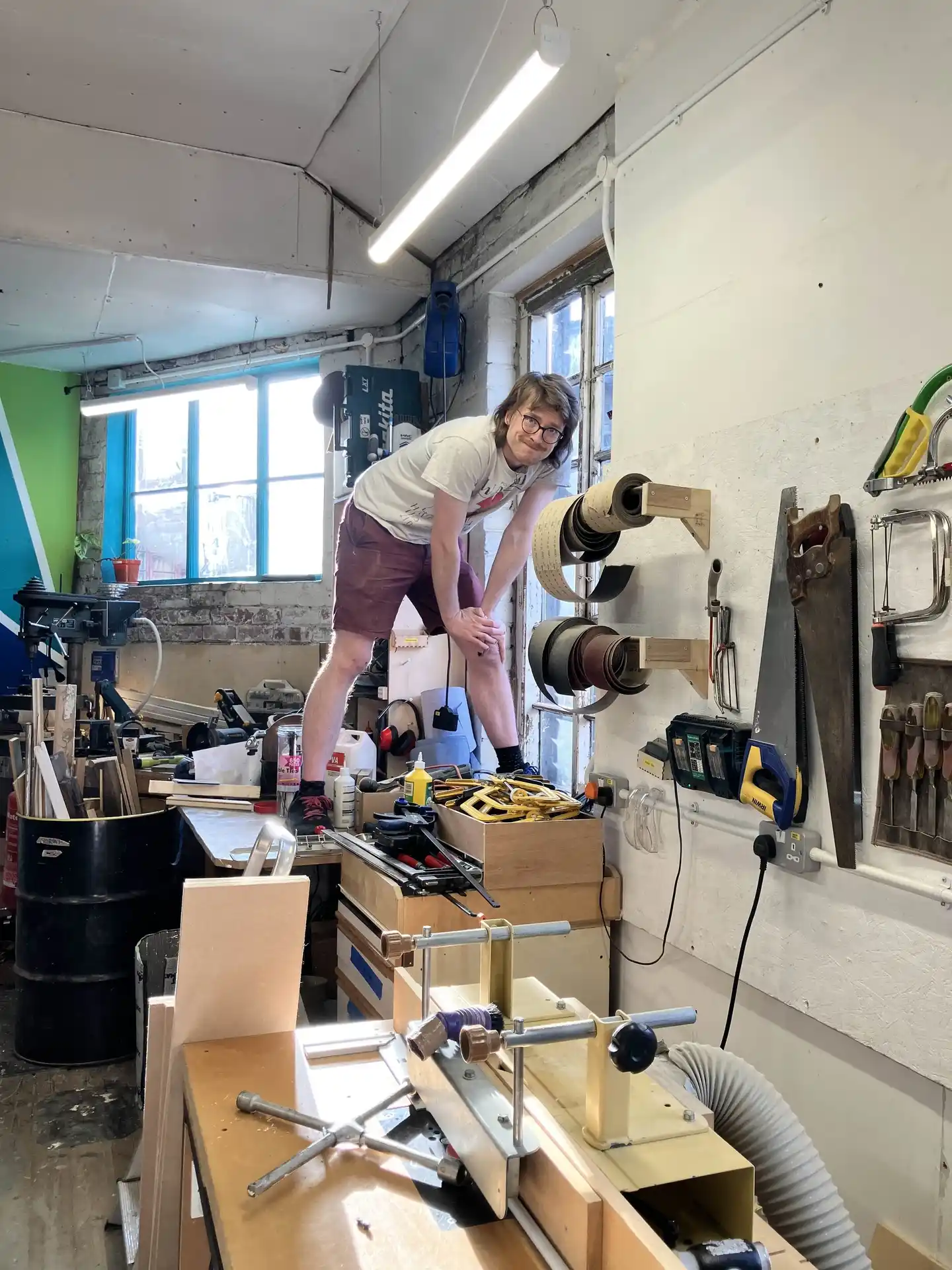 picture of a person stood on a woodworking bench top