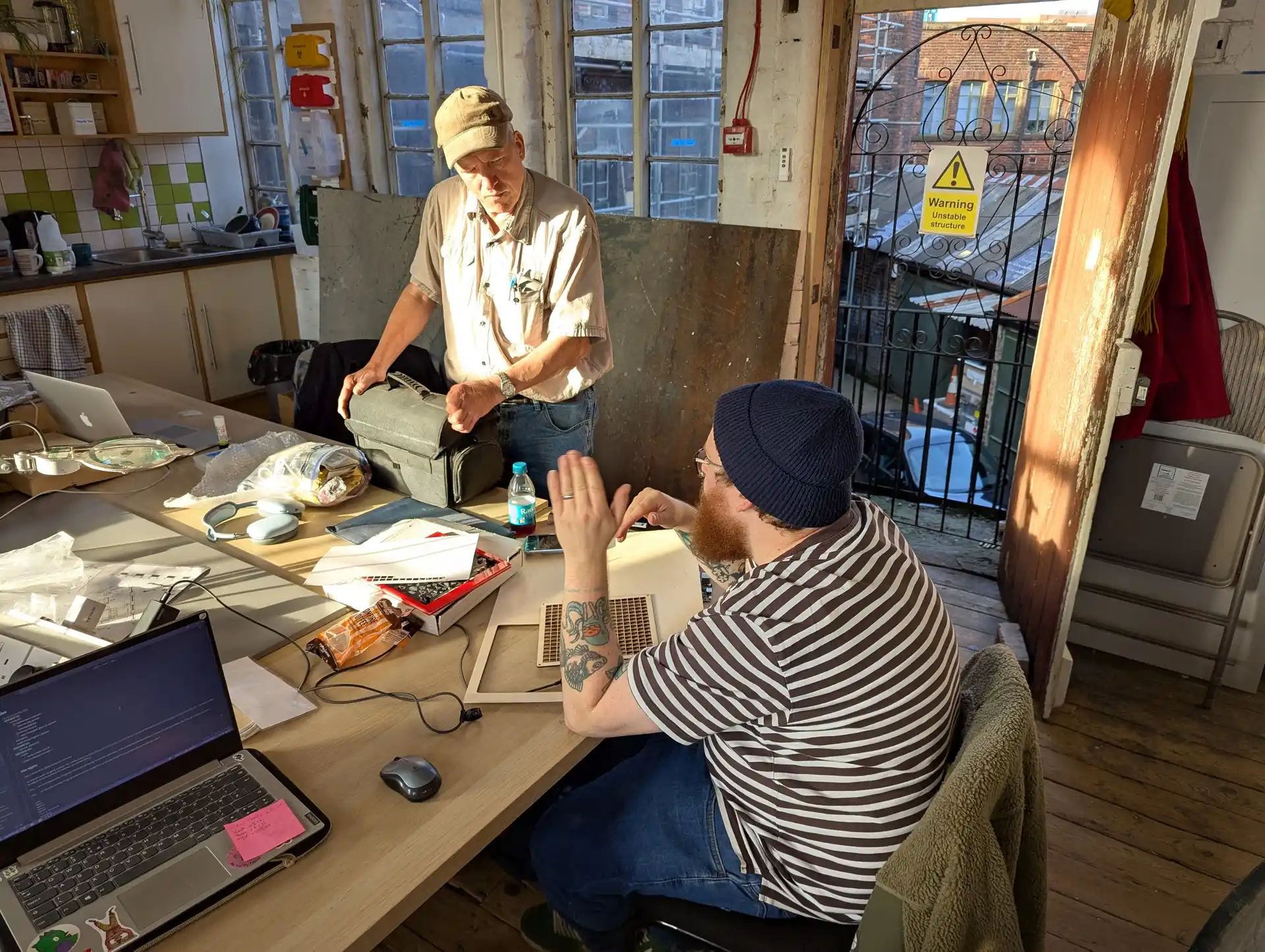 picture of two people talking sat at the common table