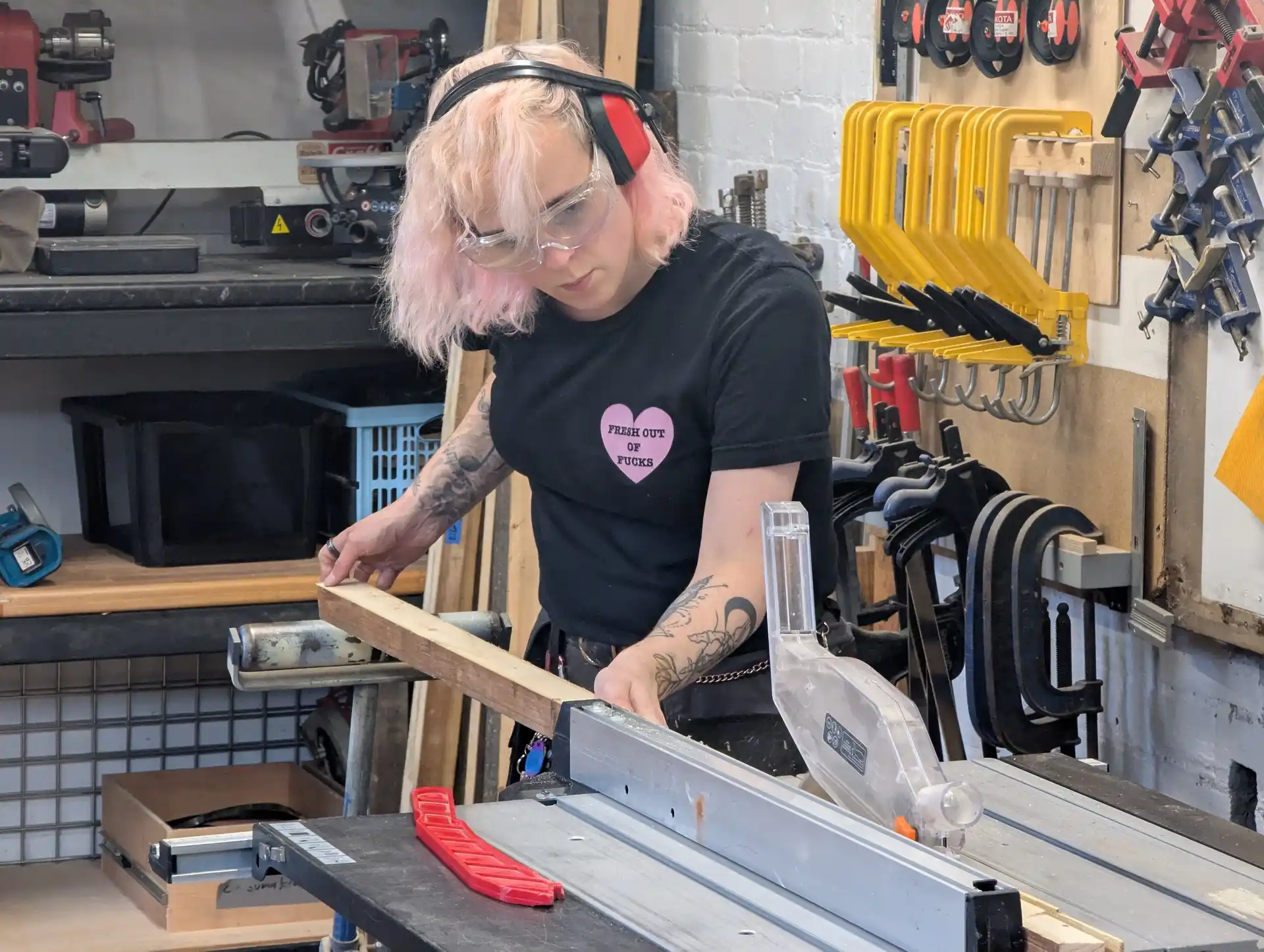 picture of person using a table saw to cut a long piece of wood