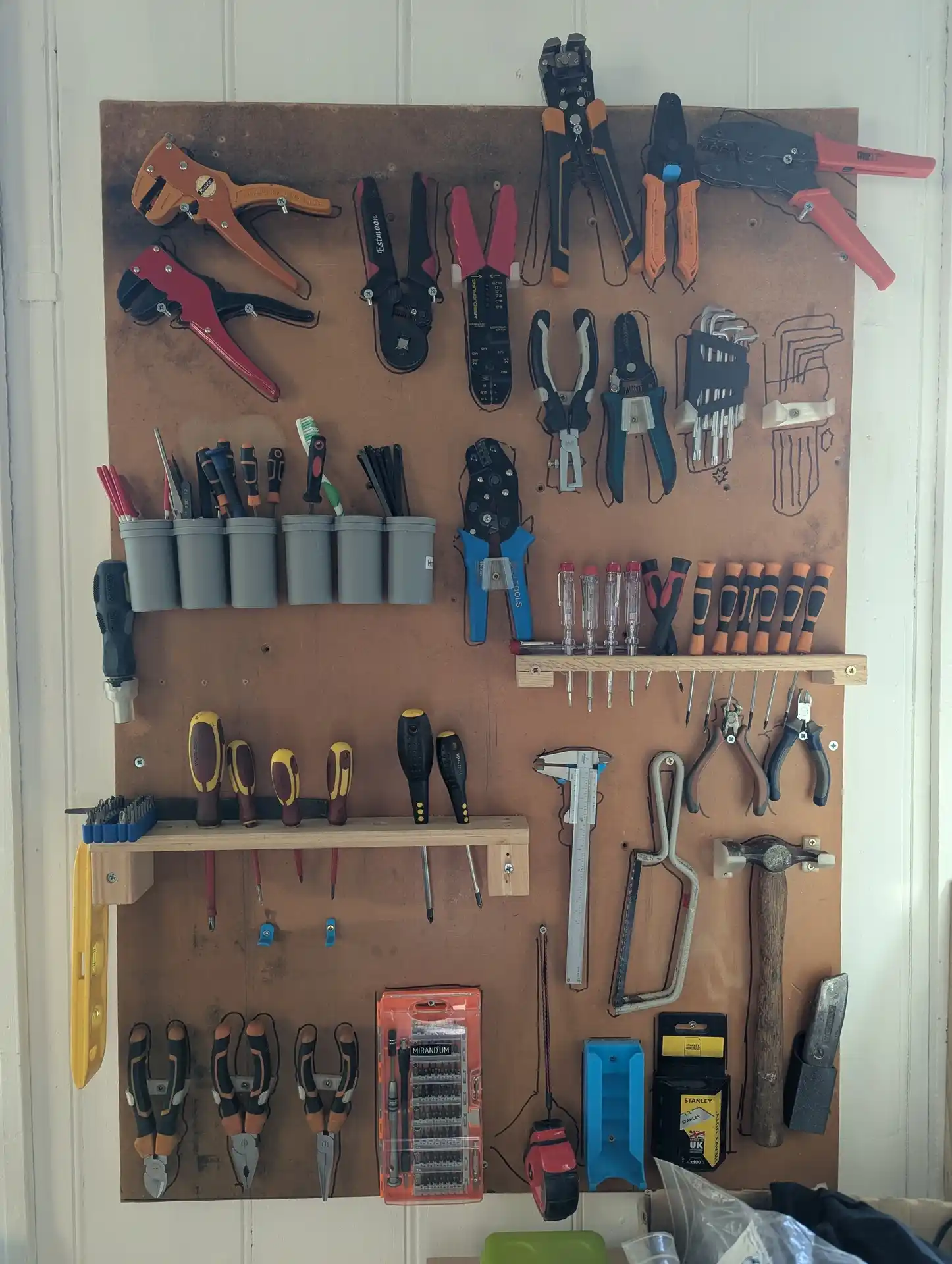 picture of a wall-mounted board with lots of tools on it