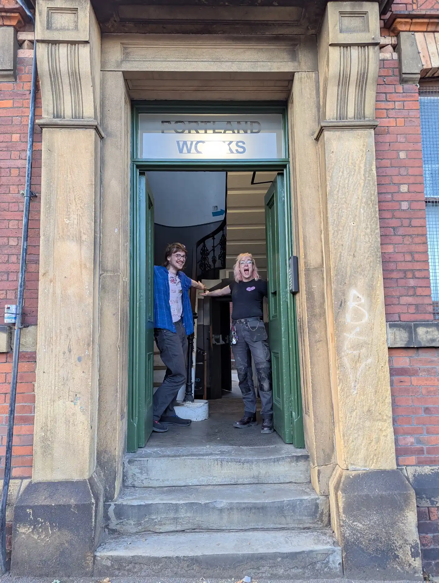 picture of two people opening a door for the viewer