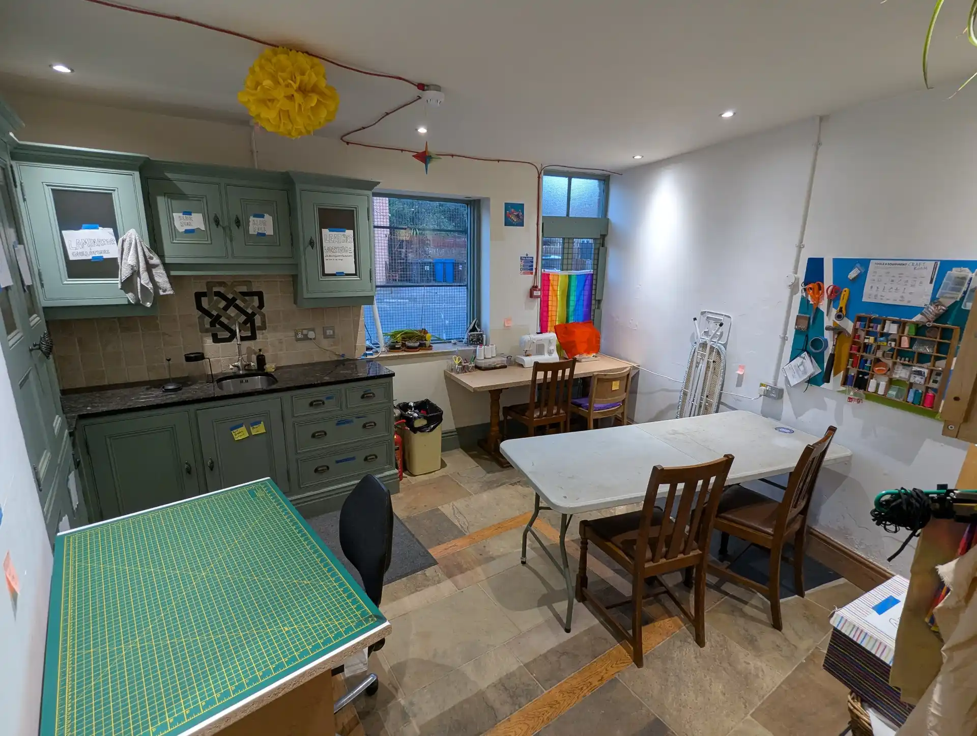 picture of a room with some craft supplies and sewing machines visible