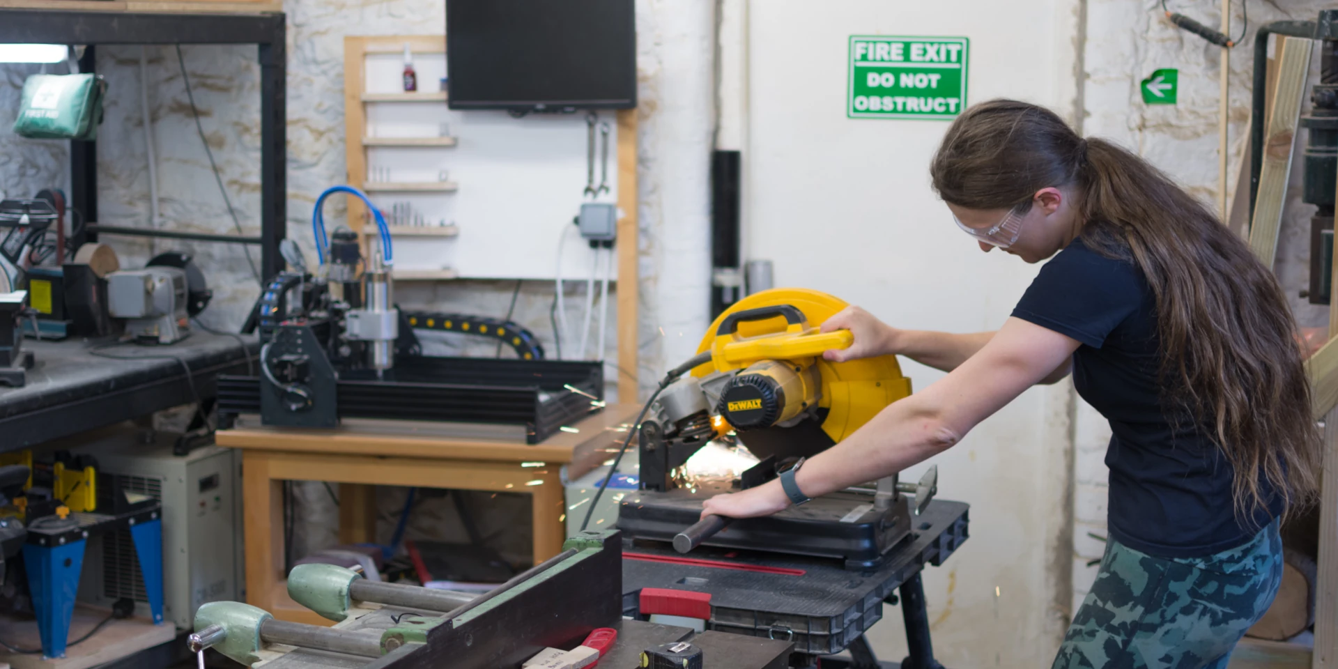 picture of a person using a saw to cut metal